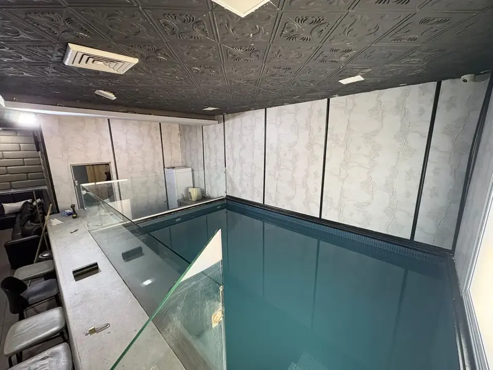 אותה בריכה לפני עריכה: מים כהים ותאורה קרה ושטוחה